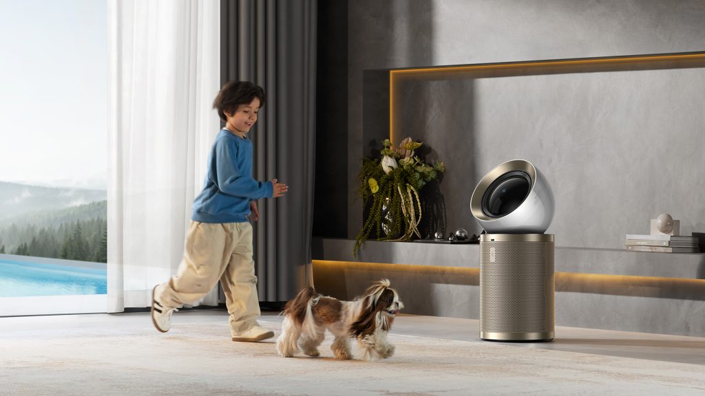 a kid playing around an air purifier with his pet.